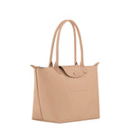 Lieblingstasche Le Pliage One M tote bag in beige leather with double top handles and a snap-button flap closure.