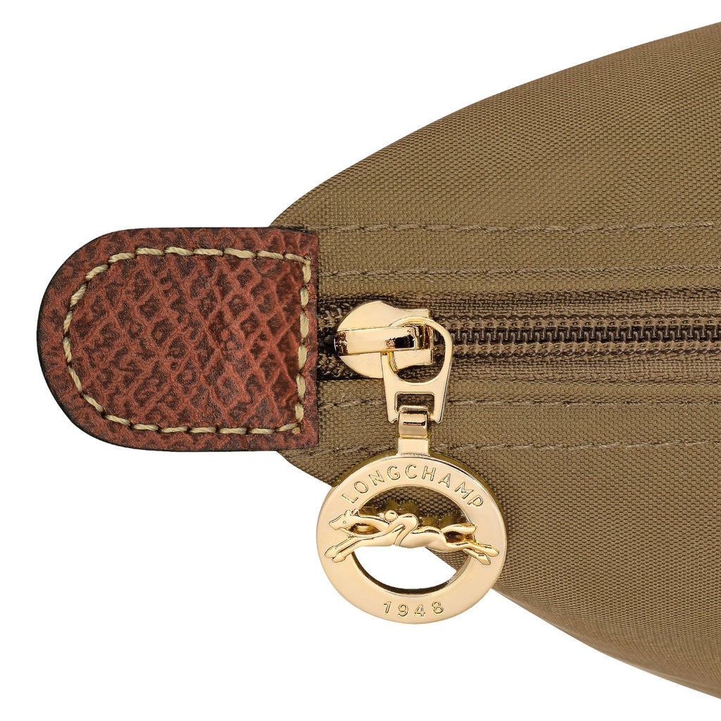 Lieblingstasche Le Pliage rucksack detail showing gold zipper pull with Longchamp logo and brown leather trim