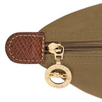 Lieblingstasche Le Pliage rucksack detail showing gold zipper pull with Longchamp logo and brown leather trim