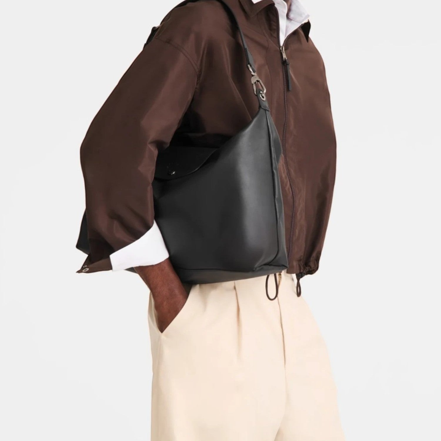 Lieblingstasche Le Pliage Xtra XL black leather shoulder bag worn by a man in a brown jacket and beige trousers