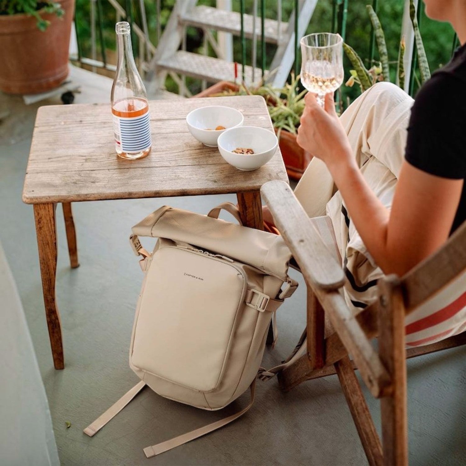 Lieblingstasche Lisbon small beige backpack with laptop compartment and anti-theft pocket on a balcony setting