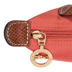 Lieblingstasche Longchamp Le Pliage Pochette in coral nylon with brown leather trim and gold logo zipper pull