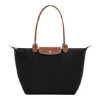 Lieblingstasche Longchamp Le Pliage large black nylon shoulder bag with brown leather handles and gold hardware.