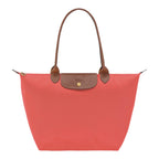 Lieblingstasche Longchamp Le Pliage large shoulder bag in coral pink nylon with brown leather trim and gold hardware.