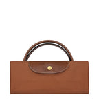 Lieblingstasche Longchamp Le Pliage travel bag folded in brown nylon with leather trim and gold snap button