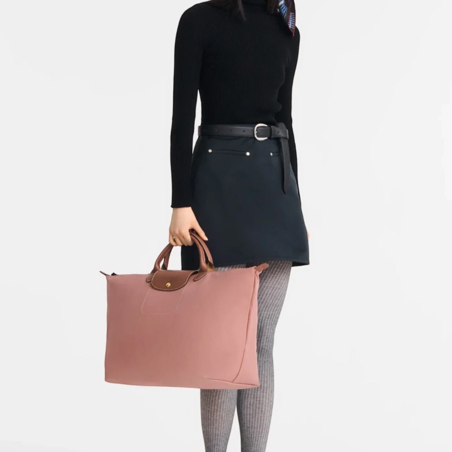 Lieblingstasche Longchamp Le Pliage large travel bag in dusty pink with brown leather handles held by a model