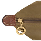Lieblingstasche Longchamp Le Pliage shoulder bag detail showing brown nylon fabric, leather trim, and gold zipper pull