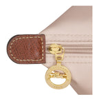Lieblingstasche Longchamp Le Pliage shoulder bag detail showing beige nylon fabric, brown leather trim, and gold zipper