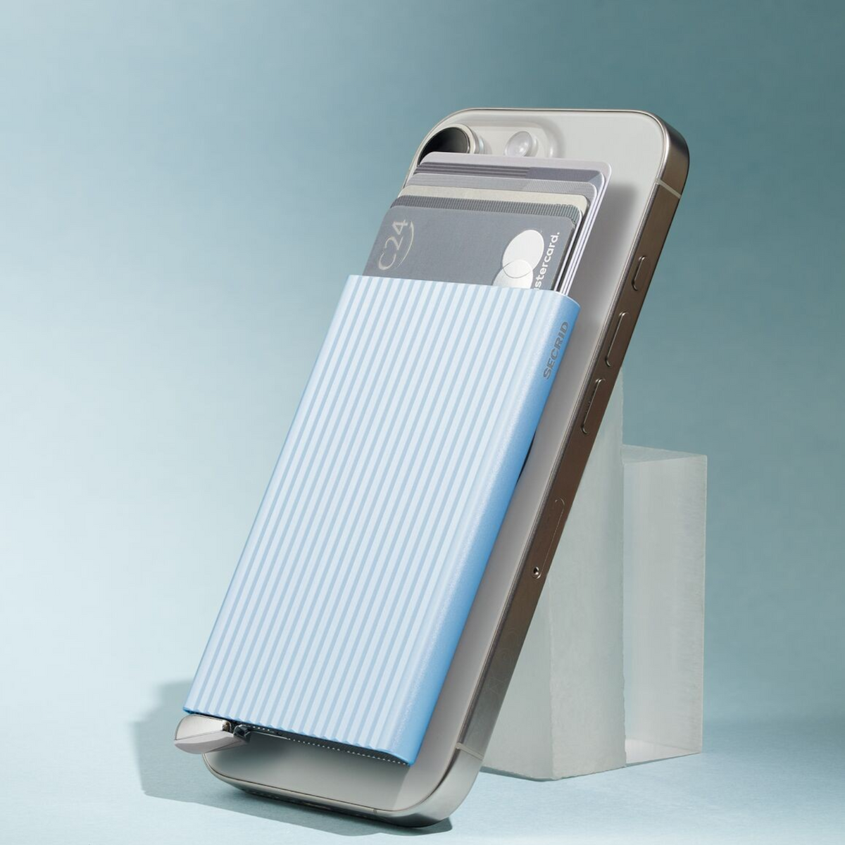 Lieblingstasche MagSafe card protector in light blue with white fluted stripes attached to a smartphone