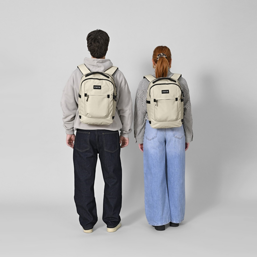 Two people wearing Lieblingstasche Midi20 beige minimalist 20L city backpacks with padded straps on a grey background