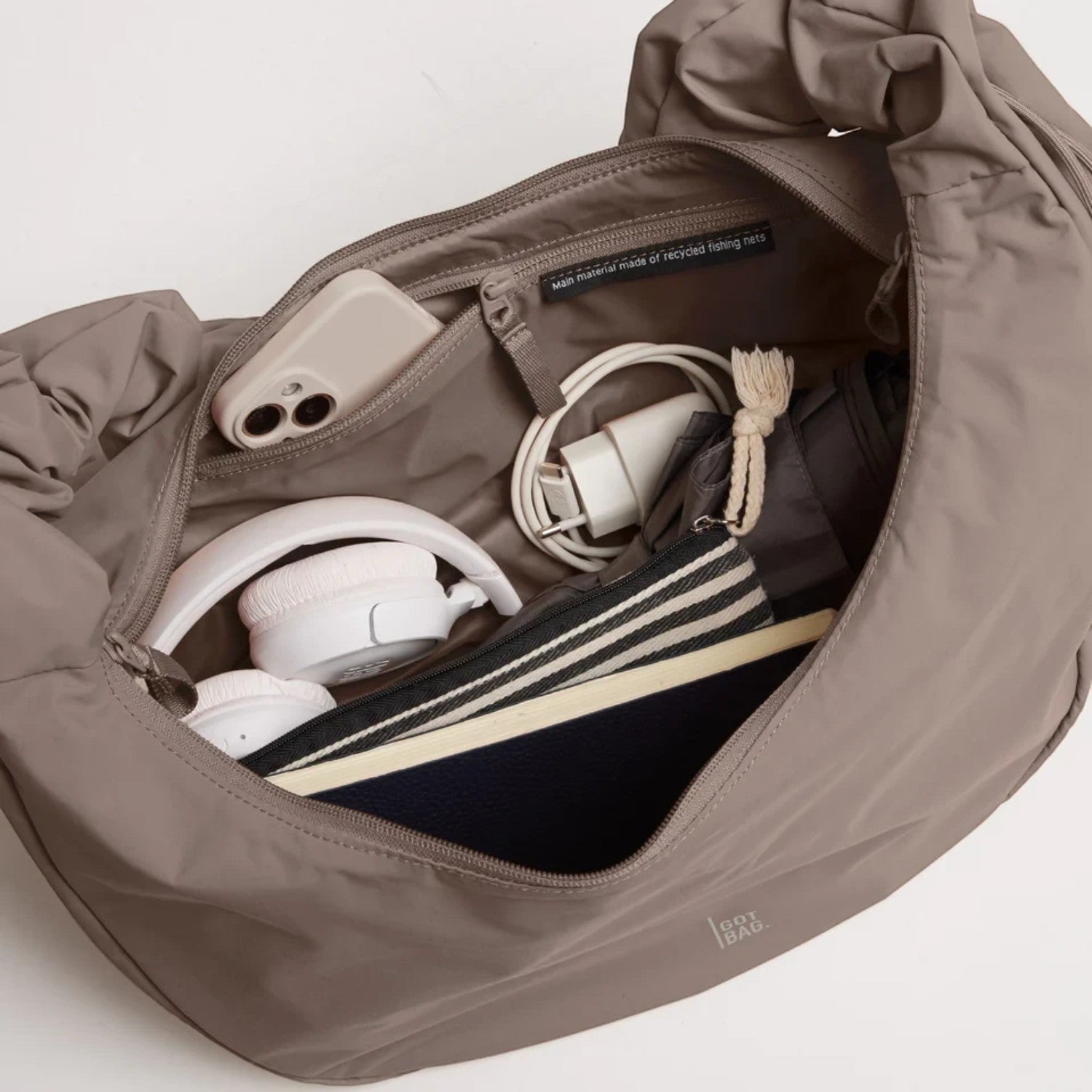 Lieblingstasche Moon Bag Ruffle Large in taupe, showing the spacious interior with organized essentials and zipper pocket.