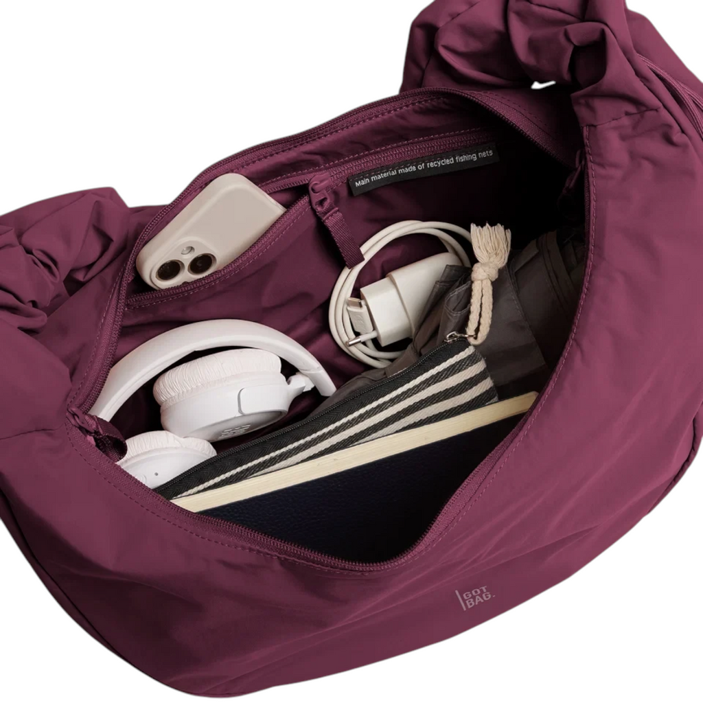 Lieblingstasche Moon Bag Ruffle Large in deep purple, showing the spacious interior filled with daily essentials.