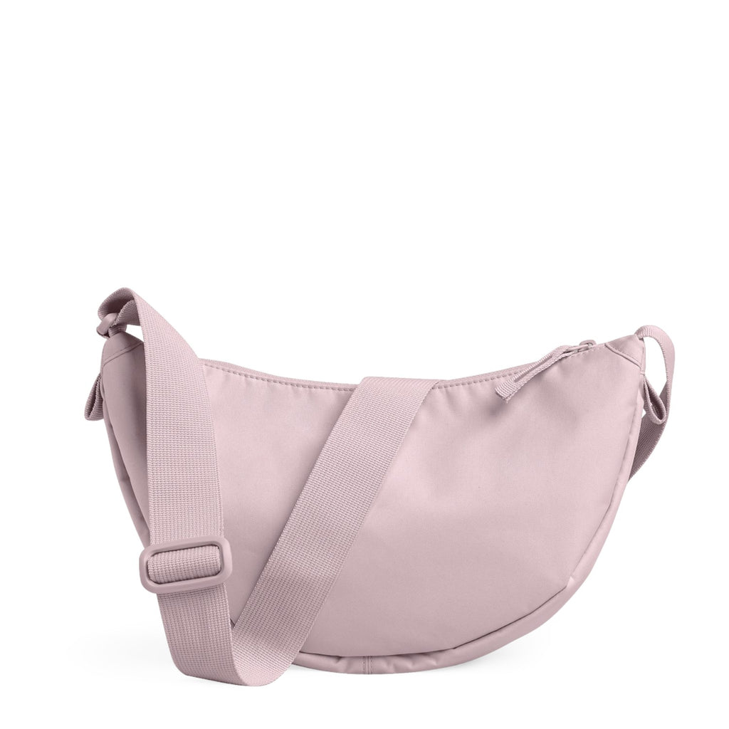 Lieblingstasche Moon Bag Small in light pink, a crescent-shaped crossbody bag with an adjustable shoulder strap.