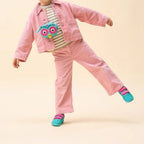 Young girl wearing a pink corduroy outfit and a Lieblingstasche owl-shaped crossbody wallet