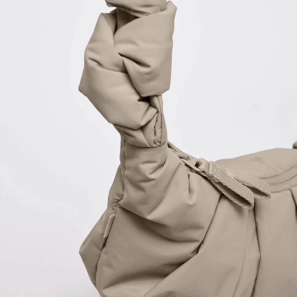 Lieblingstasche GOT BAG Pleat Moon Bag Small in beige with a knotted shoulder strap and pleated recycled fabric.
