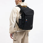 Lieblingstasche Pro Pack black laptop backpack worn by a man with a water bottle in the side mesh pocket