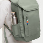 Lieblingstasche Pro Pack sage green backpack with side mesh pocket and metal water bottle on a person