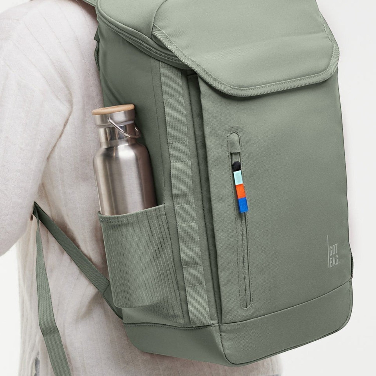 Lieblingstasche Pro Pack sage green backpack with side mesh pocket and metal water bottle on a person