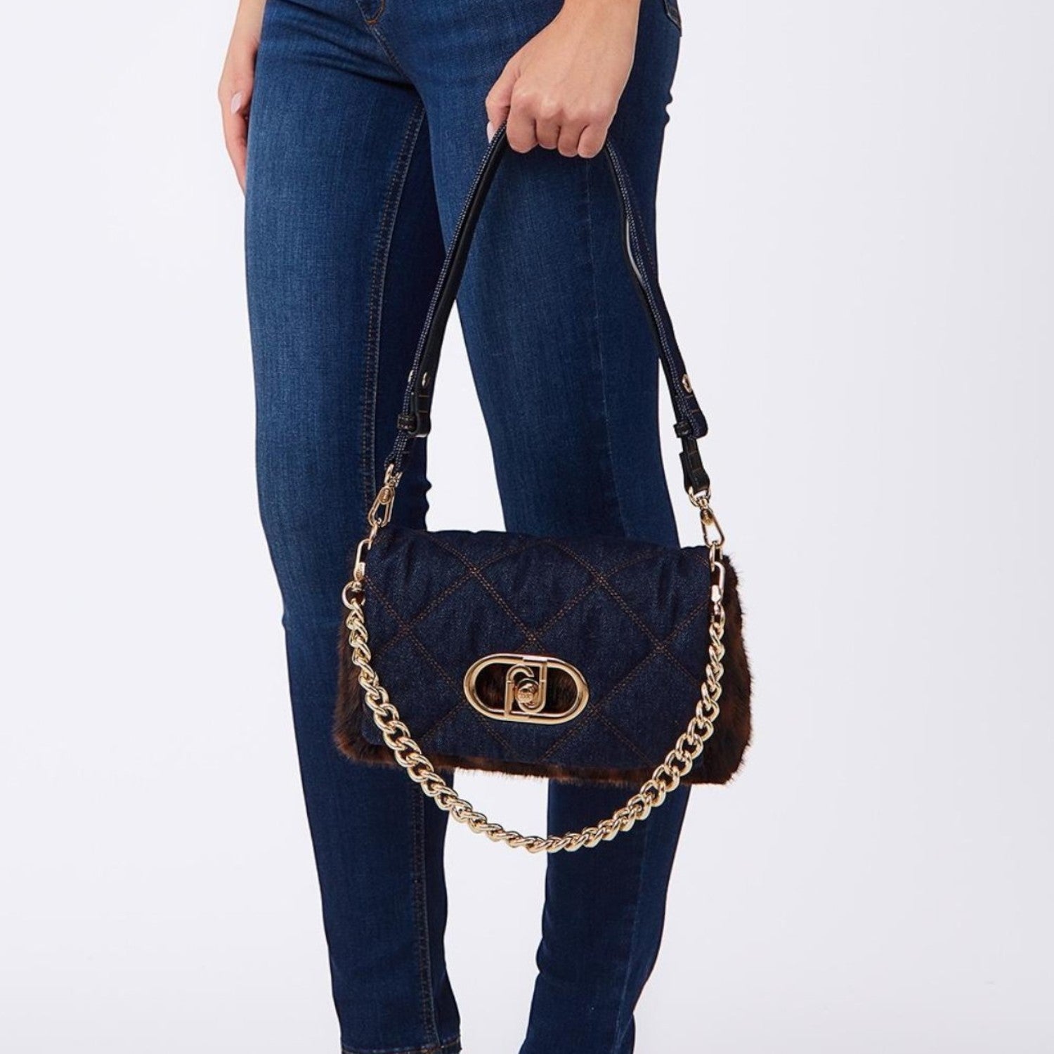 Lieblingstasche Crossbody M bag in quilted denim with brown faux fur trim, gold chain strap, and metal logo clasp.