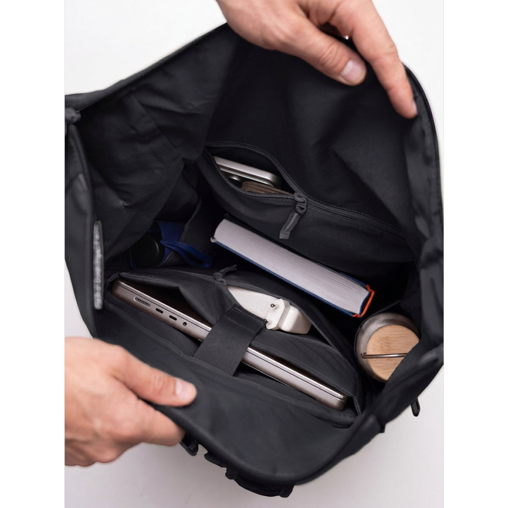 Lieblingstasche Rolltop Adventure backpack interior with laptop, book, phone, and water bottle
