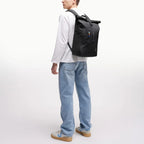 Lieblingstasche Rolltop Easy backpack in black worn by a man, featuring a flexible rolltop closure and soft fabric.