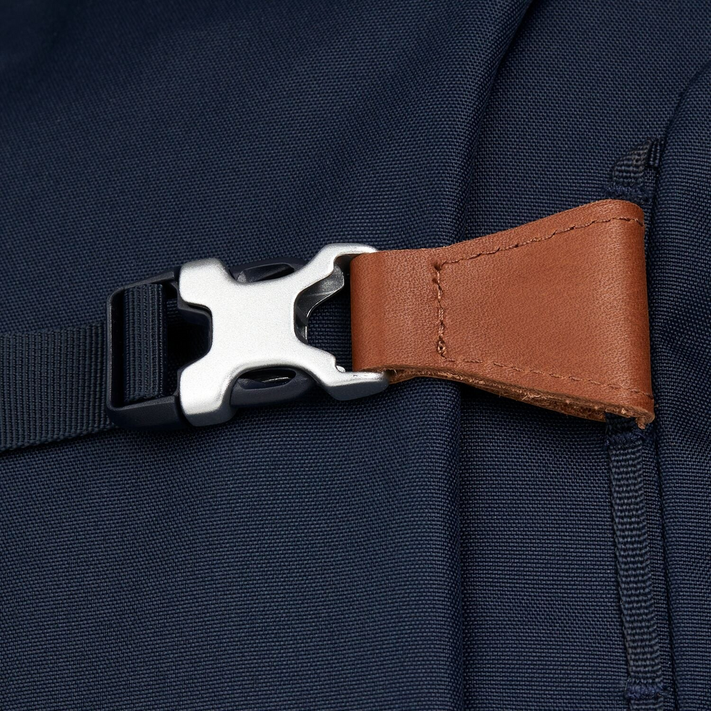 Lieblingstasche satch Pack school backpack featuring a dark blue fabric, brown leather detail, and a silver buckle.