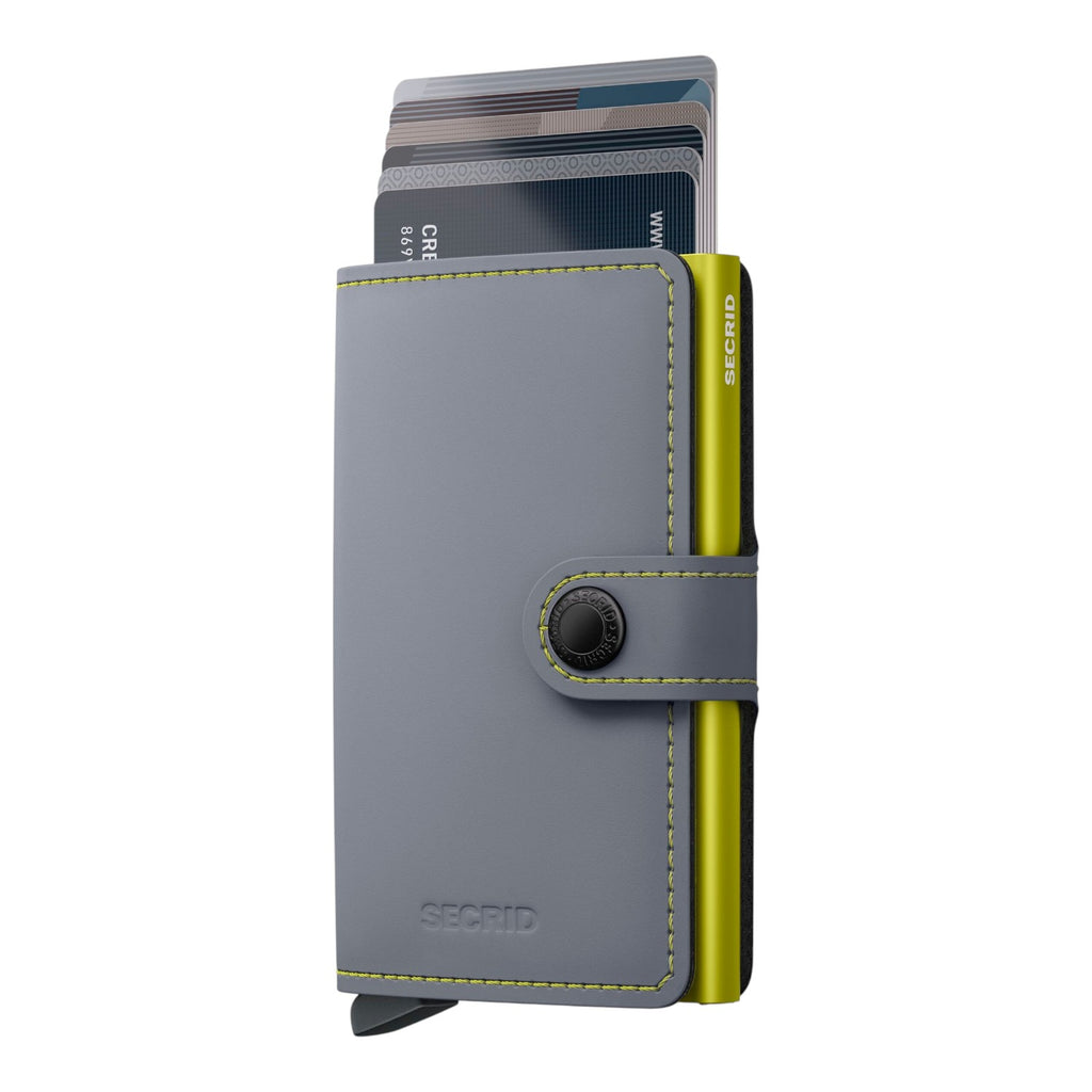 Lieblingstasche Secrid Miniwallet Matte in grey leather with a lime green aluminium card protector and snap closure.