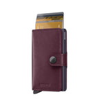 Lieblingstasche Secrid Miniwallet in dark purple leather with an integrated RFID-blocking card protector mechanism.