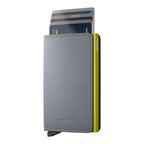 Lieblingstasche Secrid Slimwallet Matte in grey leather with a lime green aluminium card protector and card mechanism.