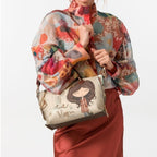 Lieblingstasche short handle bag with a whimsical girl illustration and Time to Bloom text, worn by a woman
