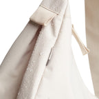 Lieblingstasche small moon bag in beige canvas with water droplets and a zippered pocket.