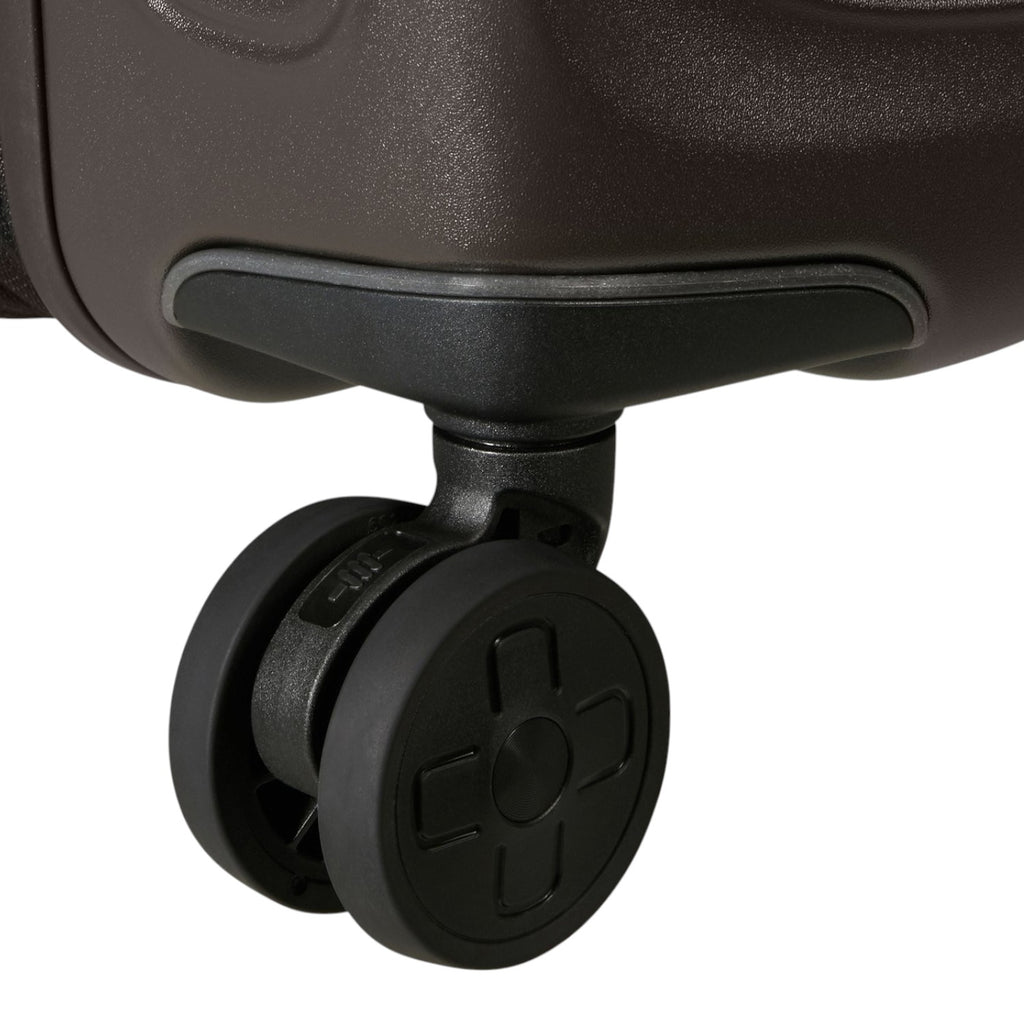 Close-up of a durable black spinner wheel on a Lieblingstasche 2WANDER suitcase against a dark brown shell.
