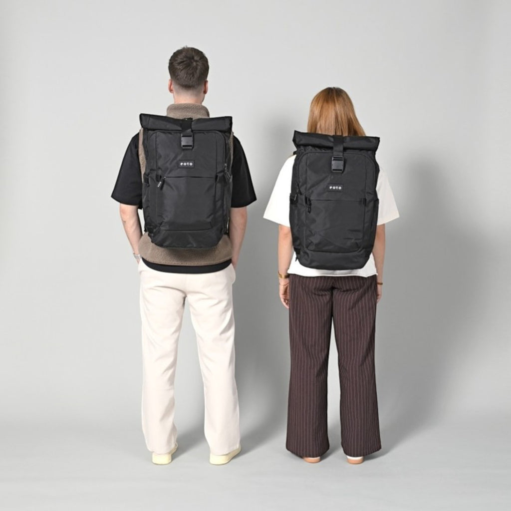 Lieblingstasche Tall41 black rolltop travel backpack worn by a man and woman showing size and fit