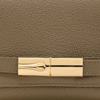 Lieblingstasche Le Smart Flow S crossbody bag in taupe grained leather with a gold-tone metal clasp detail.