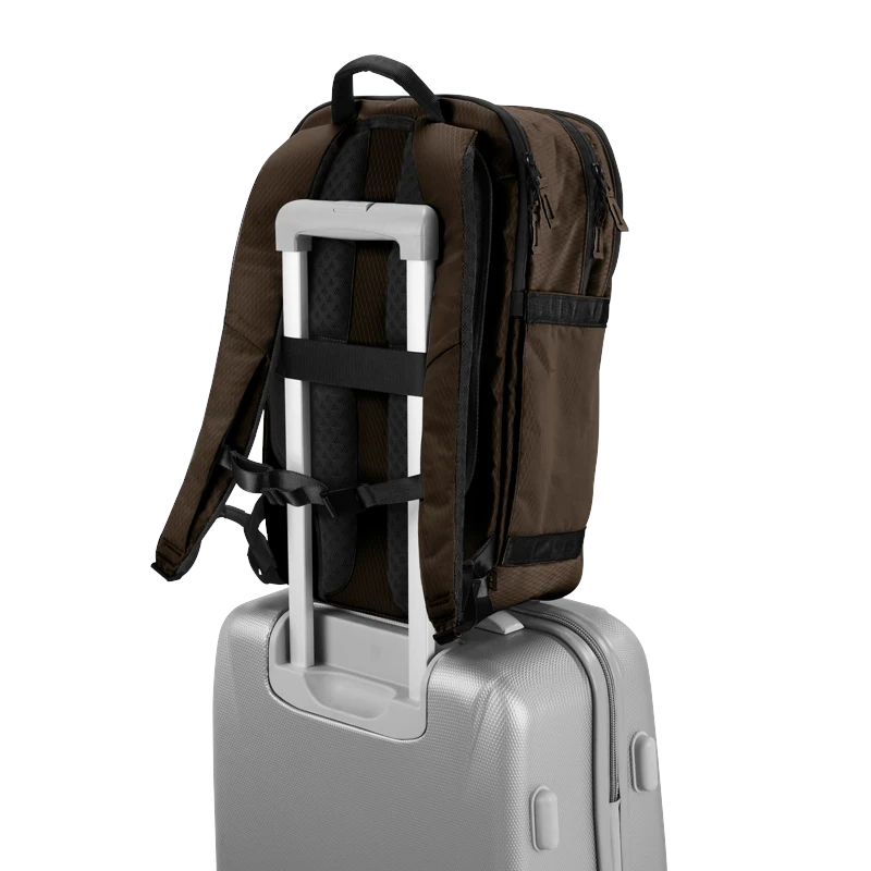 Lieblingstasche Tidy22 brown business backpack attached to a silver suitcase handle for travel