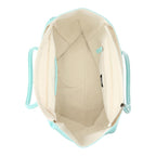 Lieblingstasche Tote L in mint green with a spacious cream interior and zippered compartment, top-down view