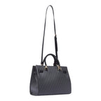 Lieblingstasche Tote M in black with a repeating logo pattern, braided top handles, and an adjustable shoulder strap.