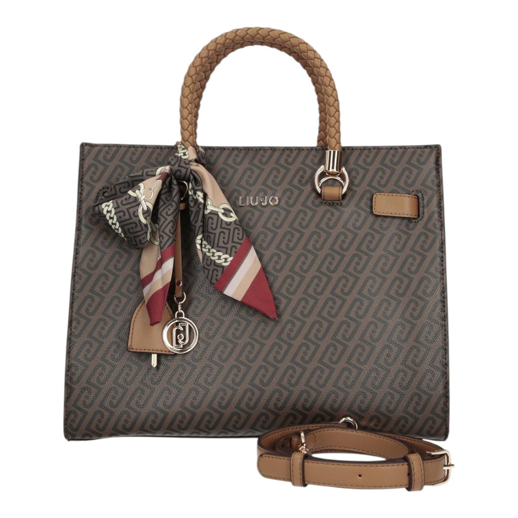 Lieblingstasche Tote M handbag in brown with a monogram pattern, braided handle, and decorative silk scarf charm.