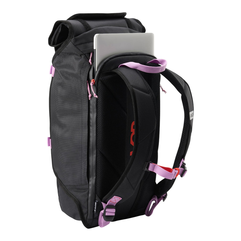 Lieblingstasche Trip Pack black roll-top backpack with laptop compartment, pink accents, and padded shoulder straps.