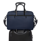 Lieblingstasche Tumi Alpha navy blue medium 15-inch expandable briefcase mounted on a black rolling suitcase handle