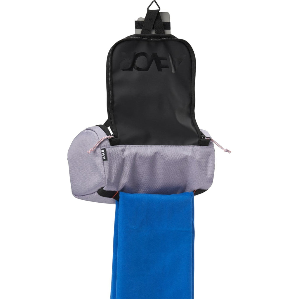 Lieblingstasche Wash Pack in light purple with a hanging hook, open compartment, and a blue towel attached.