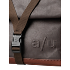 Lieblingstasche Yao brown canvas backpack with a brown strap, black buckle, and embossed a/u logo detail.