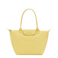 Lieblingstasche yellow leather tote bag with snap closure pocket and top handles.